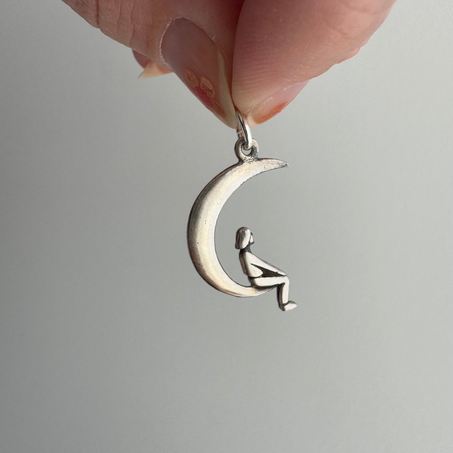 P R E - L O V E D // lunar perspective / sterling silver person sitting on a crescent moon / a pendant