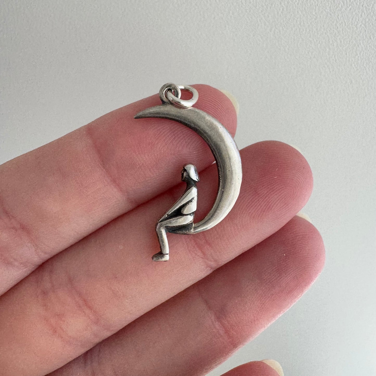 P R E - L O V E D // lunar perspective / sterling silver person sitting on a crescent moon / a pendant