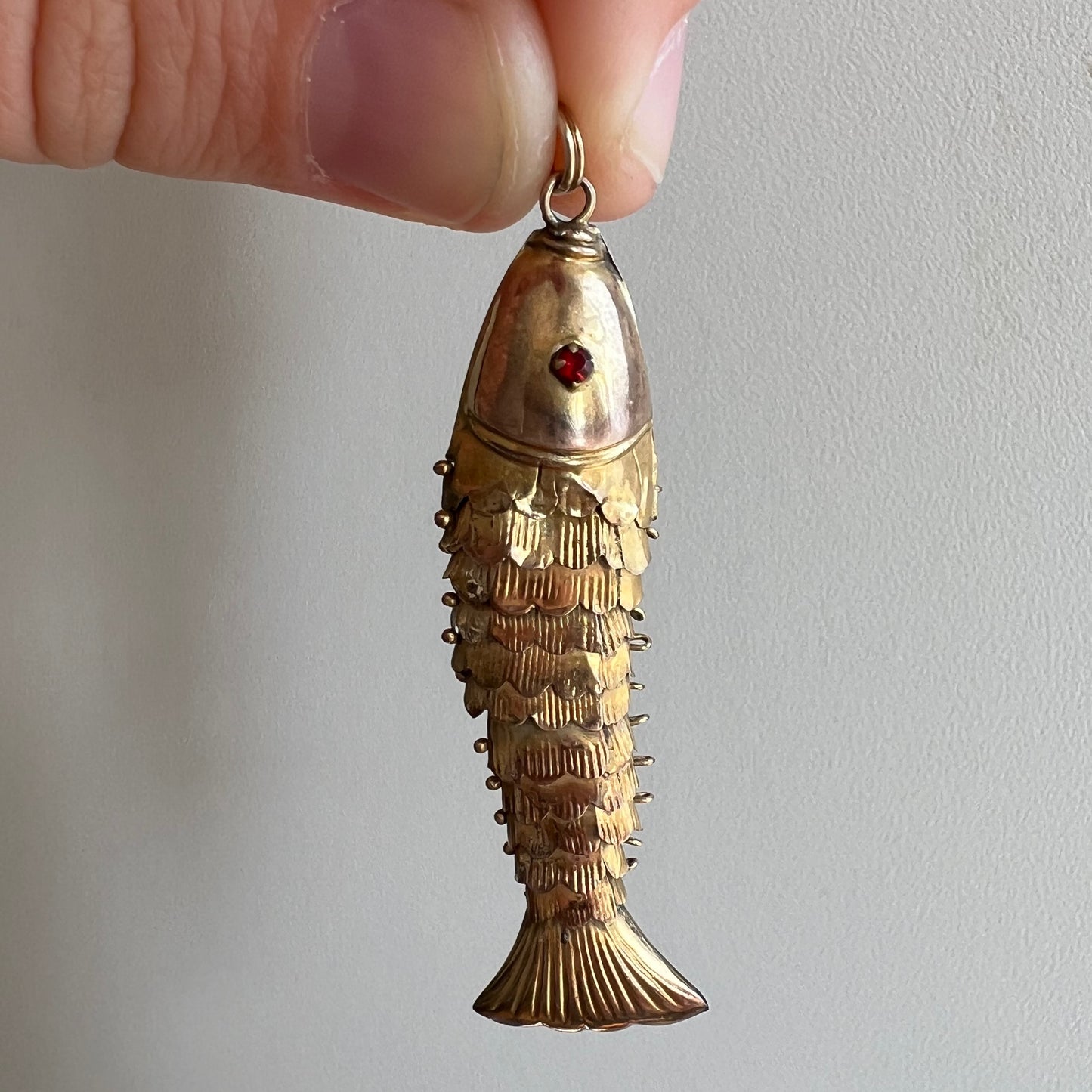 A N T I Q U E // resilient articulation / 14k rosy yellow gold and red glass articulated wiggle fish / a pendant