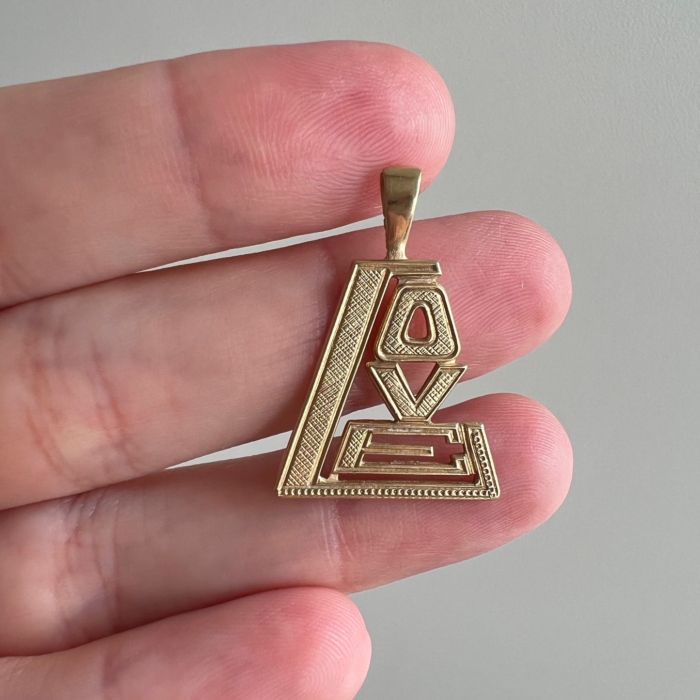 V I N T A G E // 1970s love / 14k yellow gold stylized LOVE / a pendant