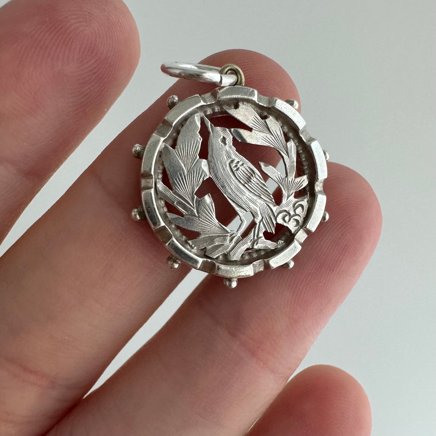 A N T I Q U E // the lookout / sterling silver bird and foliage in a detailed round frame / a pendant