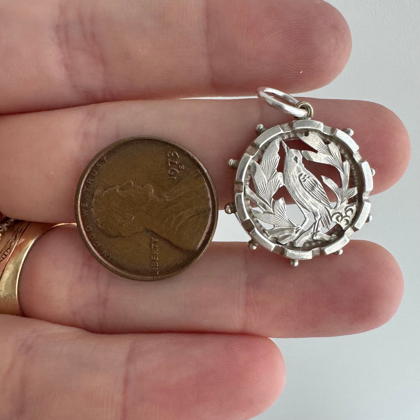 A N T I Q U E // the lookout / sterling silver bird and foliage in a detailed round frame / a pendant