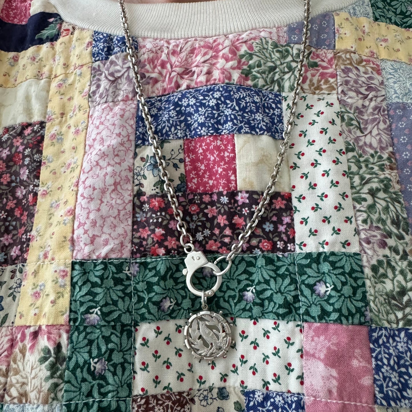 A N T I Q U E // the lookout / sterling silver bird and foliage in a detailed round frame / a pendant